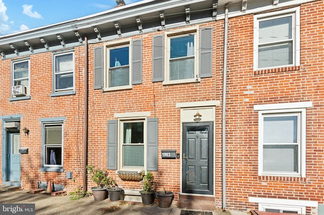 townhome / multi-family property featuring brick siding