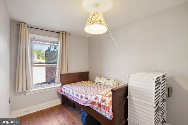 bedroom with baseboards and wood-type flooring
