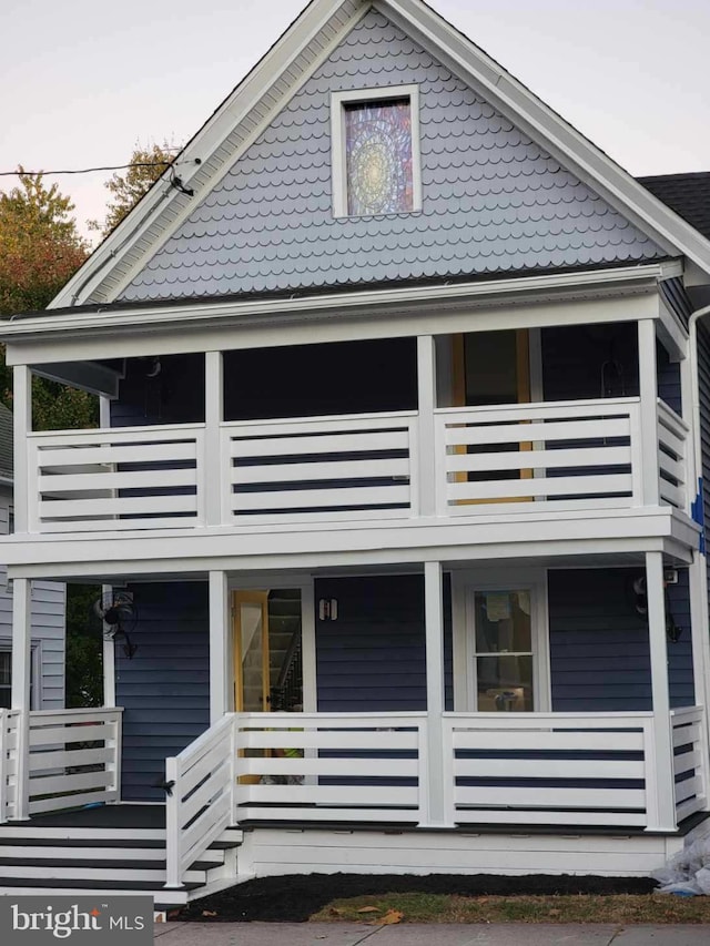 rear view of house featuring a balcony