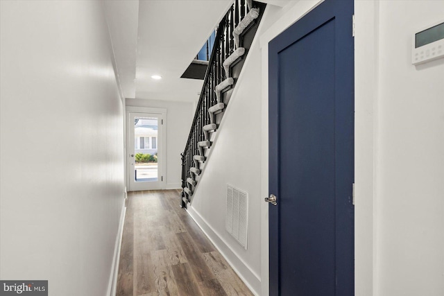 hallway with hardwood / wood-style floors