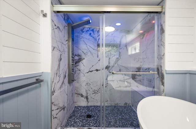 bathroom with wooden walls and independent shower and bath