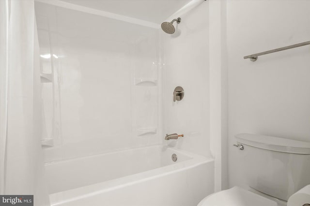 bathroom with shower / bathing tub combination and toilet