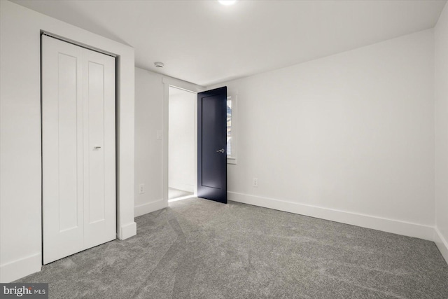 unfurnished bedroom featuring light carpet and a closet