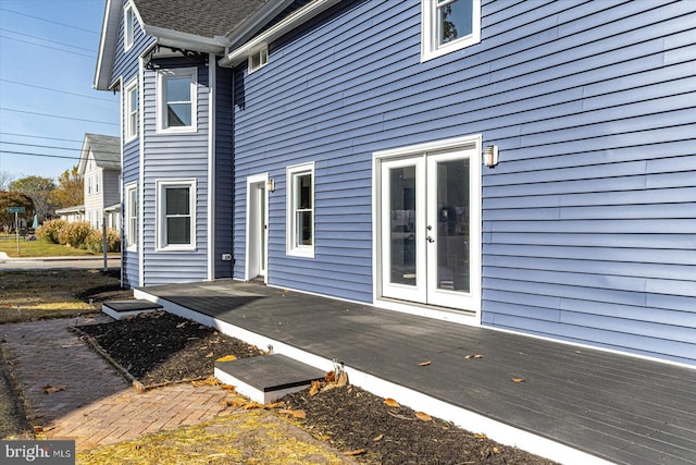 view of home's exterior featuring french doors and a wooden deck