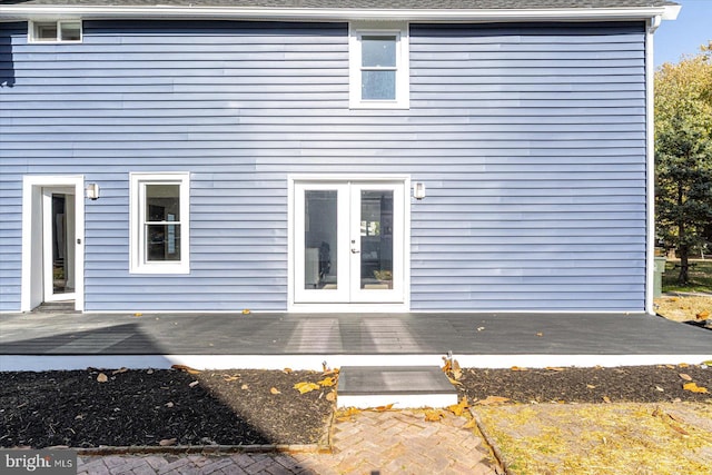 back of property featuring french doors and a deck