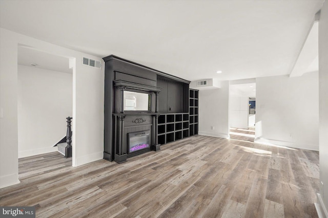 unfurnished living room featuring wood-type flooring