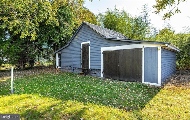 view of outbuilding with a lawn