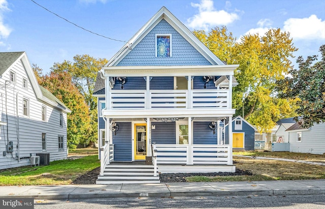 victorian-style house featuring a balcony and covered porch