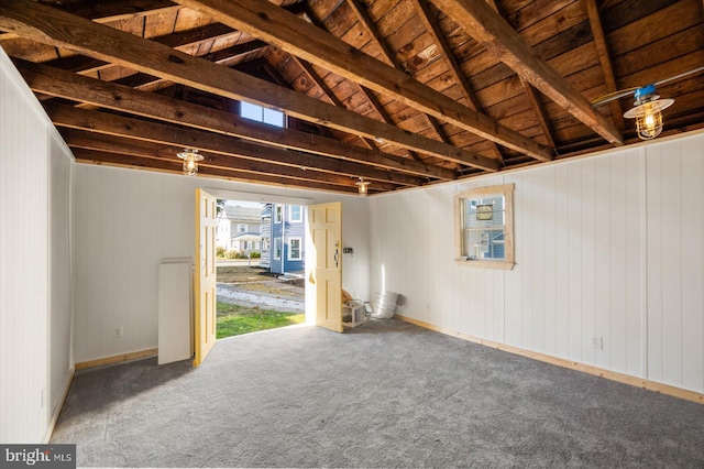 interior space with vaulted ceiling with beams, wood ceiling, carpet floors, and wooden walls