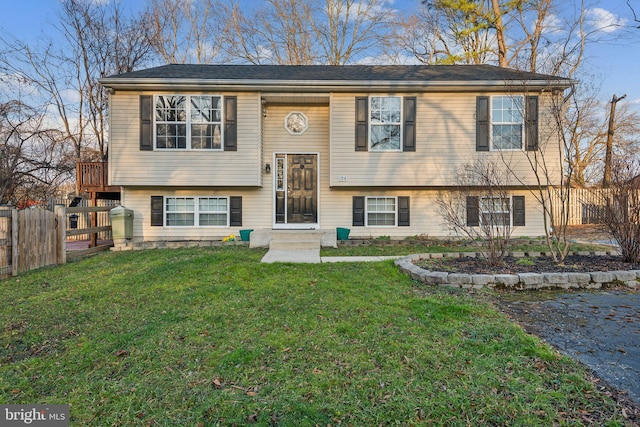 raised ranch featuring a front lawn