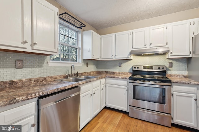 kitchen with white cabinetry, sink, stainless steel appliances, and a textured ceiling