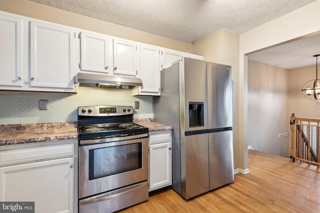 kitchen with white cabinets, a notable chandelier, and appliances with stainless steel finishes