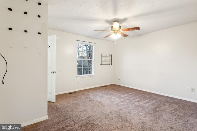 empty room with ceiling fan and carpet