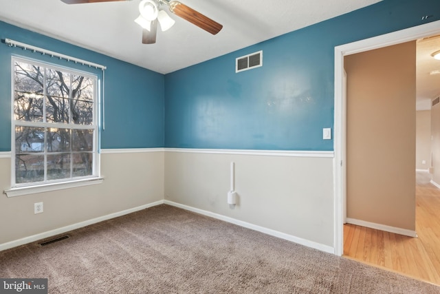 spare room featuring carpet flooring and ceiling fan