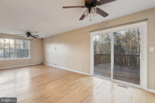 spare room with ceiling fan and light wood-type flooring