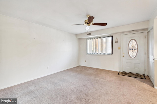 foyer entrance with light carpet and ceiling fan