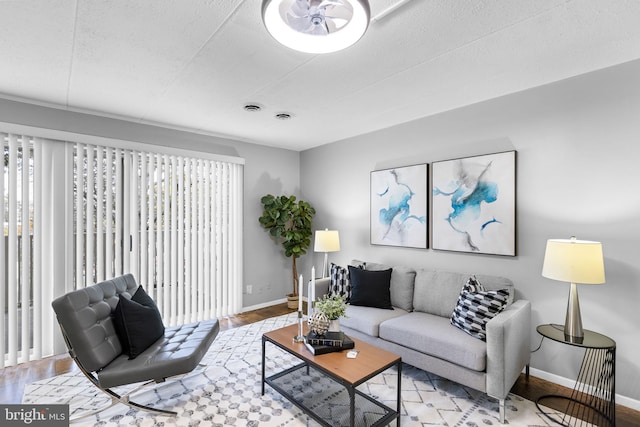 living room featuring light hardwood / wood-style floors and a textured ceiling