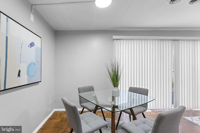 dining space with parquet floors