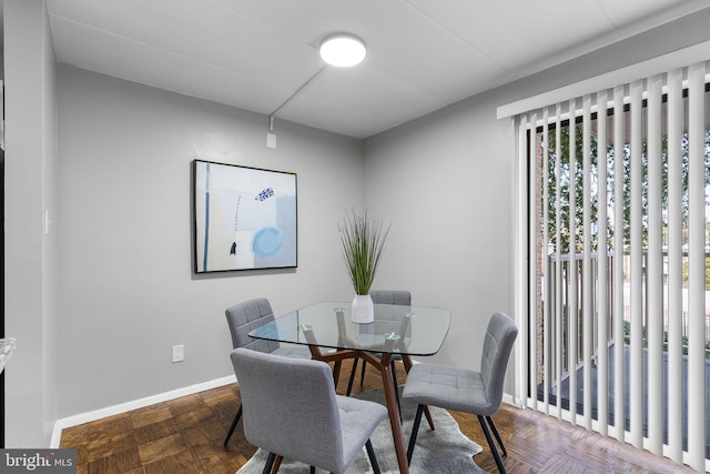 dining space with dark parquet floors