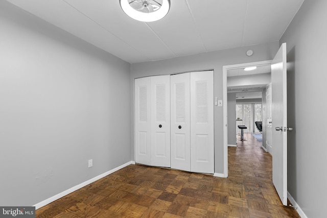 unfurnished bedroom with dark parquet flooring