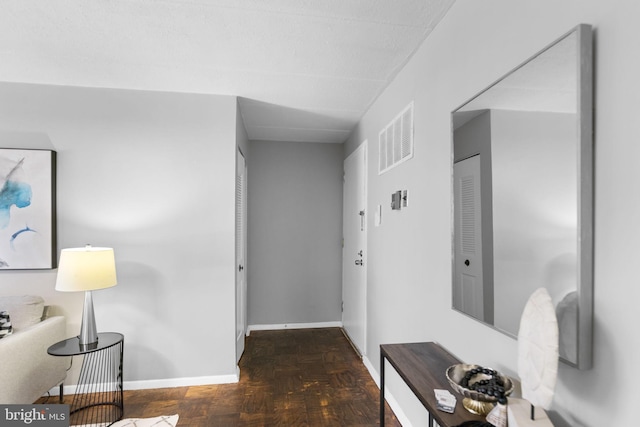 hallway featuring dark parquet floors