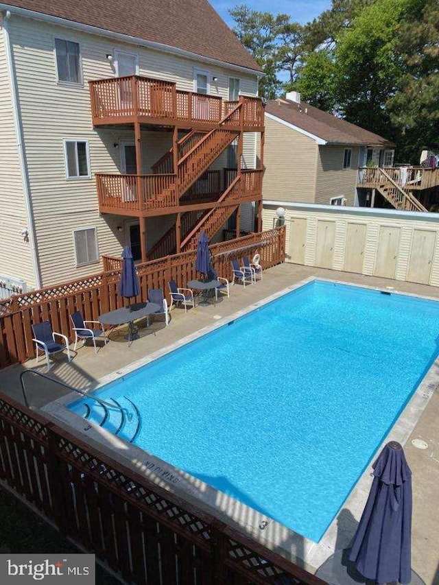 pool featuring a deck and stairs