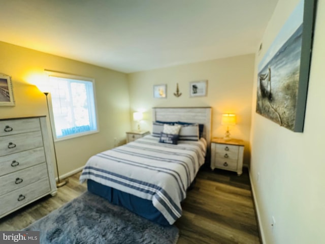 bedroom with dark hardwood / wood-style floors