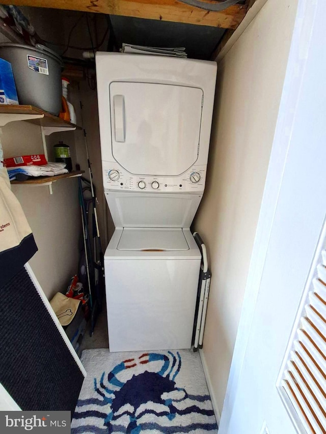 laundry room with stacked washer / drying machine