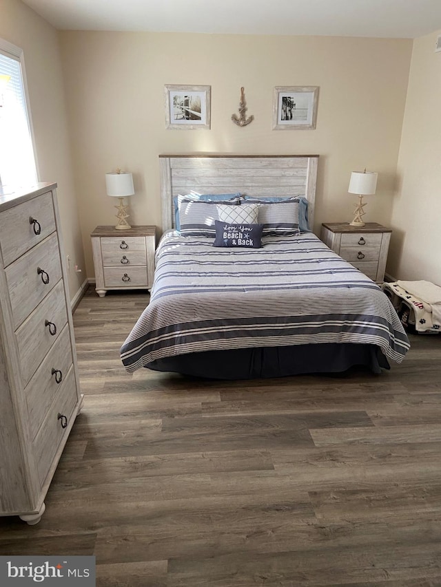 bedroom with dark hardwood / wood-style flooring