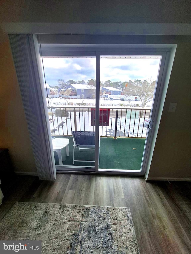 doorway to outside featuring wood finished floors and a healthy amount of sunlight
