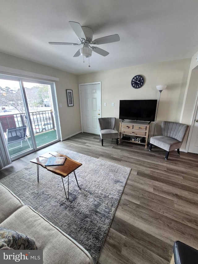 living room featuring a ceiling fan and wood finished floors
