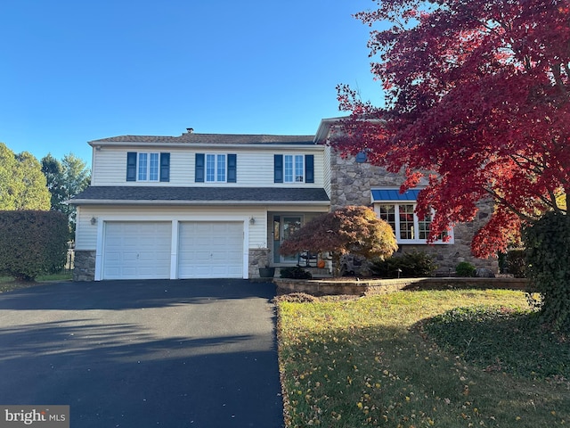 front of property featuring a garage and a front lawn