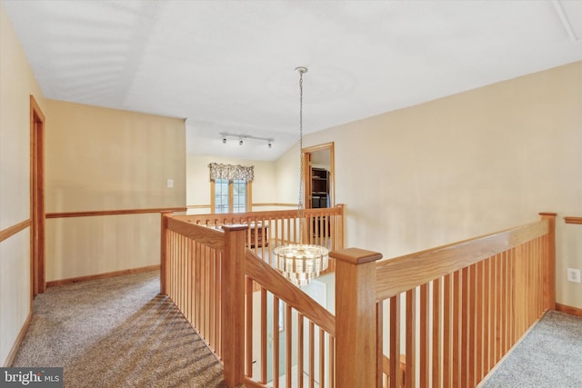 corridor with light carpet and track lighting