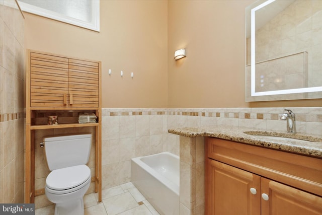 bathroom featuring tile walls, tile patterned floors, a tub to relax in, and toilet