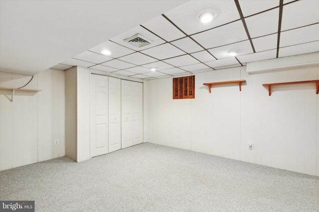 basement with carpet floors and a drop ceiling