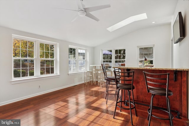 interior space featuring dark hardwood / wood-style flooring, lofted ceiling, and ceiling fan