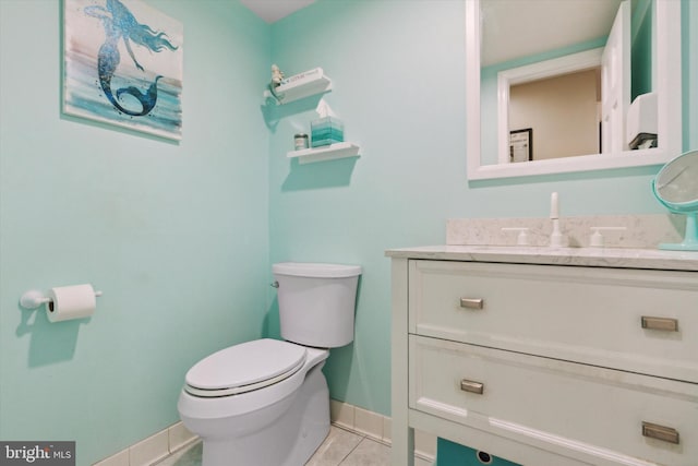 bathroom with vanity, tile patterned flooring, and toilet