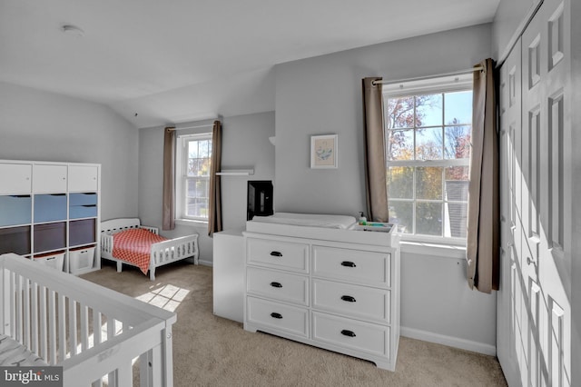 bedroom with light carpet, baseboards, and vaulted ceiling