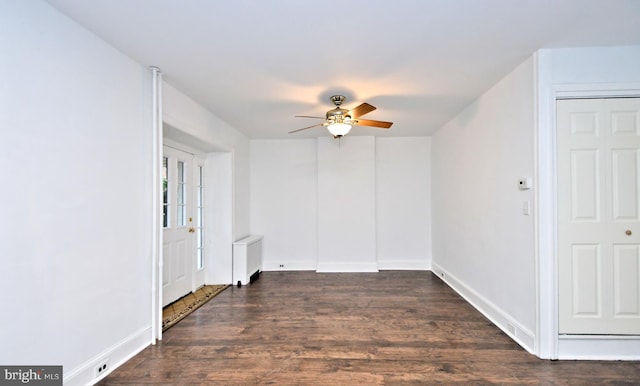 interior space featuring dark wood-type flooring, radiator heating unit, and ceiling fan