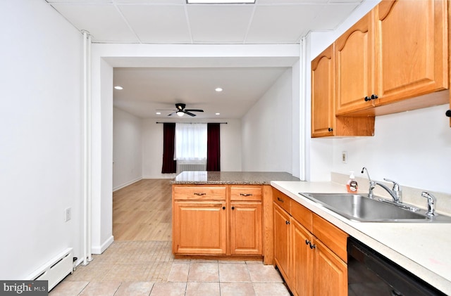 kitchen with sink, light tile patterned floors, ceiling fan, dishwasher, and baseboard heating