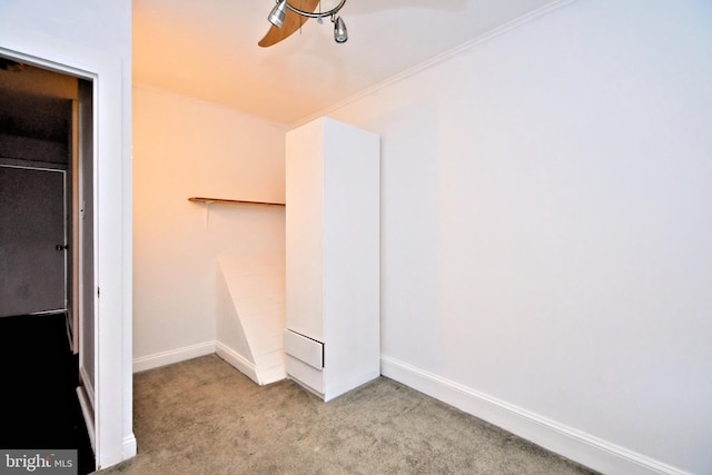 spacious closet featuring light colored carpet and ceiling fan