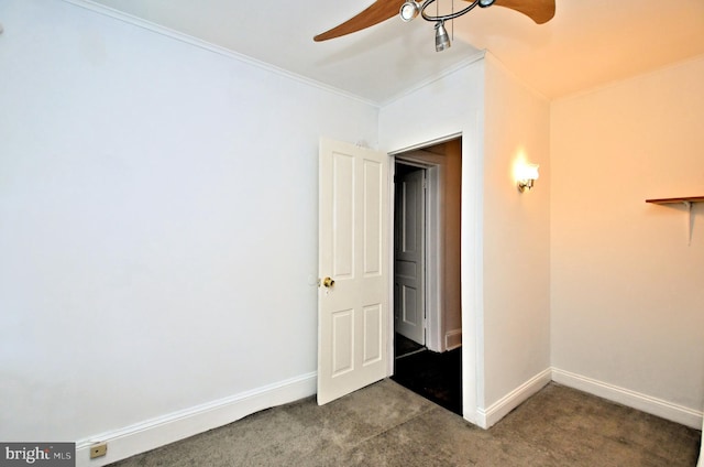 carpeted empty room with ceiling fan and ornamental molding