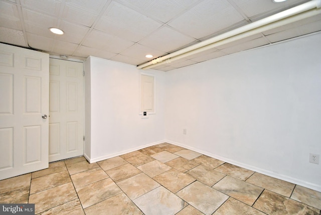 basement with light tile patterned flooring