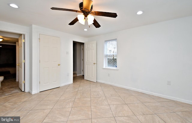 unfurnished bedroom featuring light tile patterned floors and ceiling fan