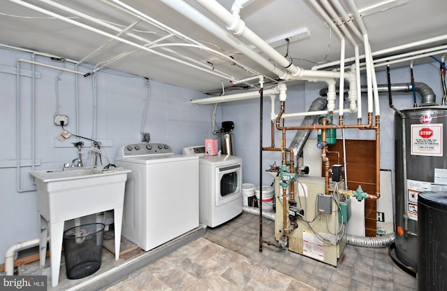 washroom with separate washer and dryer and gas water heater