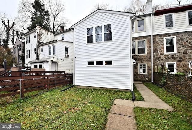 back of house featuring a yard