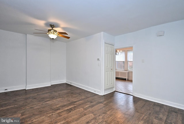 unfurnished room with ceiling fan, radiator, and dark hardwood / wood-style floors