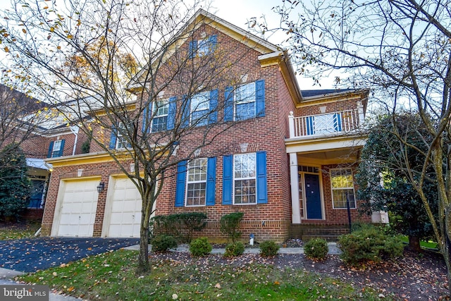 multi unit property with a balcony and a garage