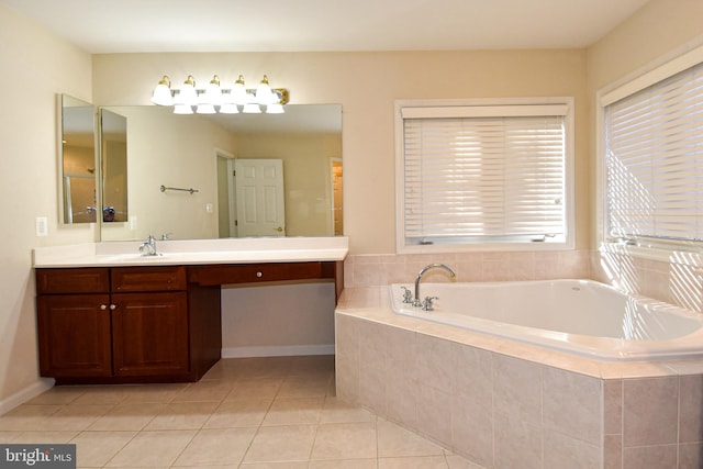 bathroom featuring vanity, a relaxing tiled tub, and tile patterned floors