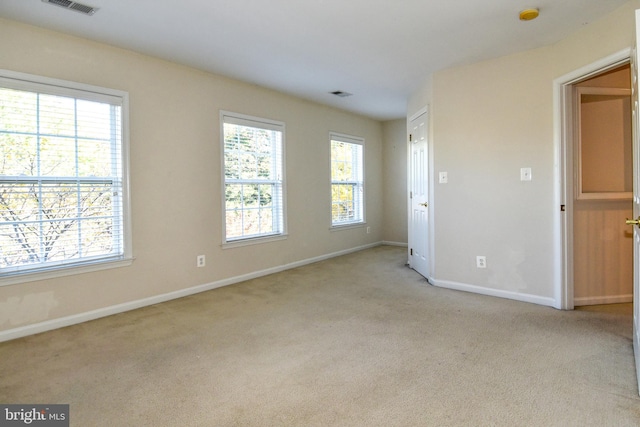 unfurnished bedroom with multiple windows and light colored carpet